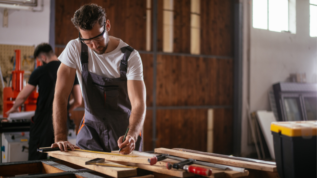 Young expert carpenter deep in his work of custom crafting carpentry designs