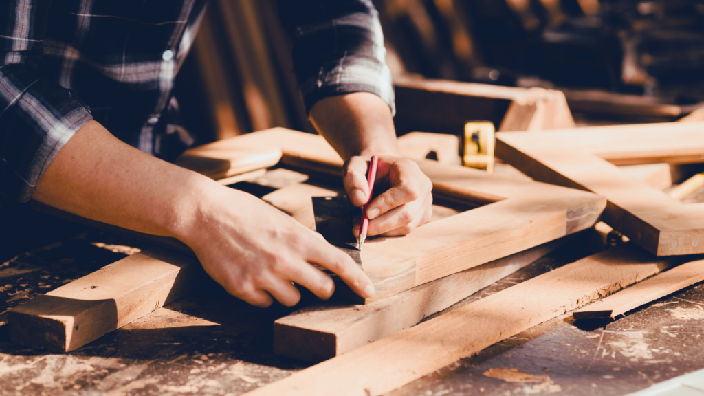 a young carpenter deep in his working of crafting beautiful hand-crafted building frames for a burbank house