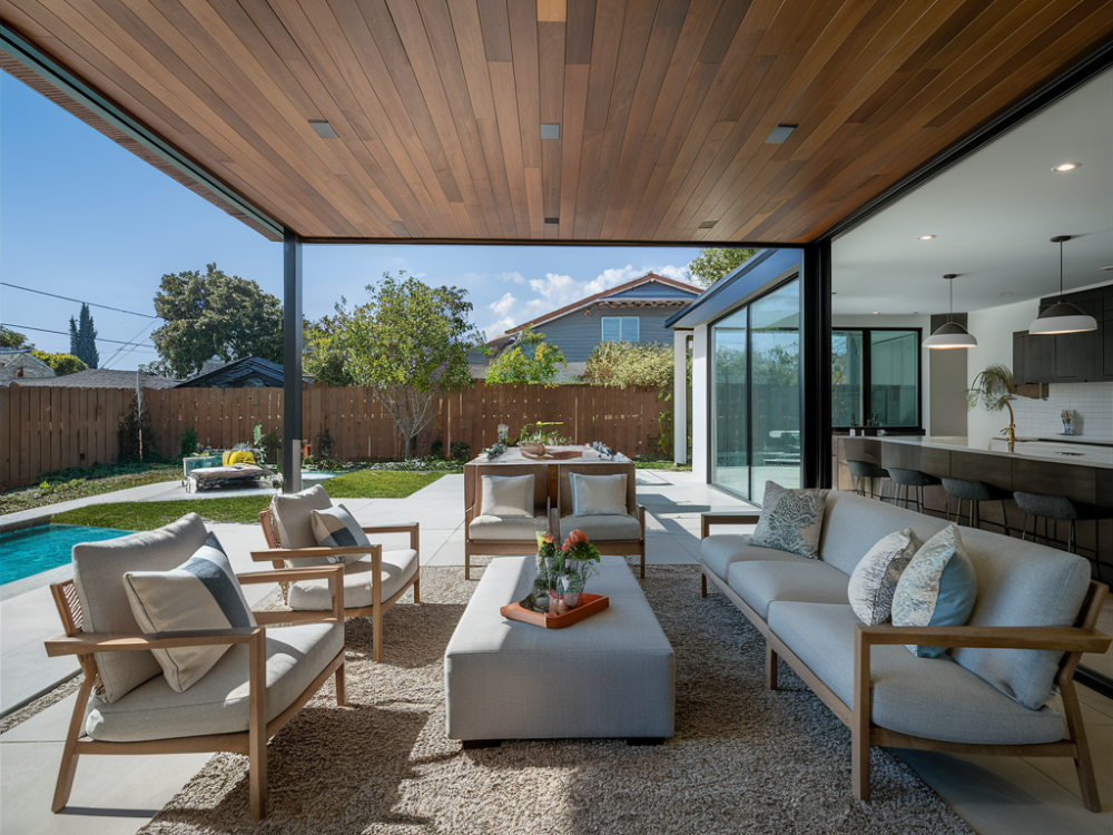 An open sunroom created by extending a house towards the poolside