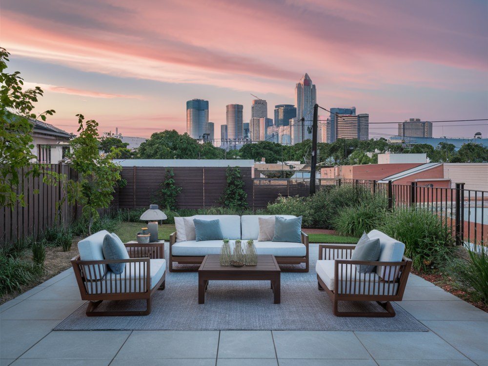 A contemporary patio in a suburban backyard with the los angeles skyline in the background