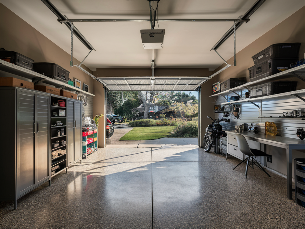 A modern garage with vehicle parking space, a workbench, hardware equipment overlooking a beautiful Los Angeles residential area Sunset